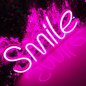 SMILE - neon LED illuminated light sign hanging on the wall